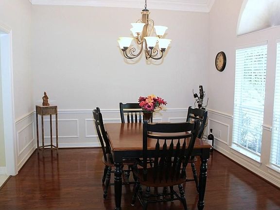 Formal Dining Room w/wood flooring & big windows to let in natural light.