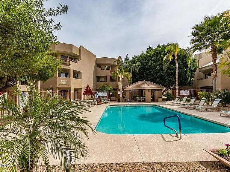 Pool and jacuzzi. Unit is located right about. the red umbrella; second floor