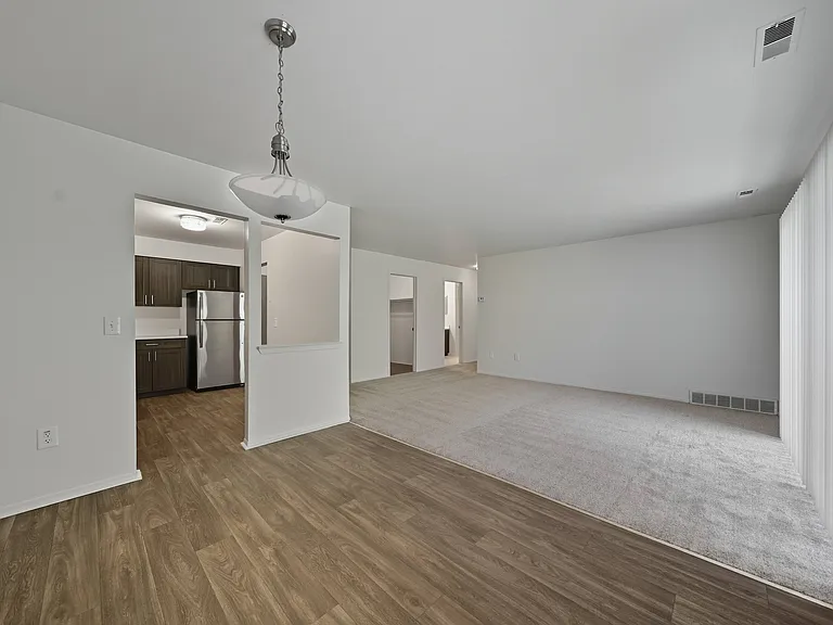 Open Living/Dining Room with natural light at Franklin River Apartments in Southfield, MI