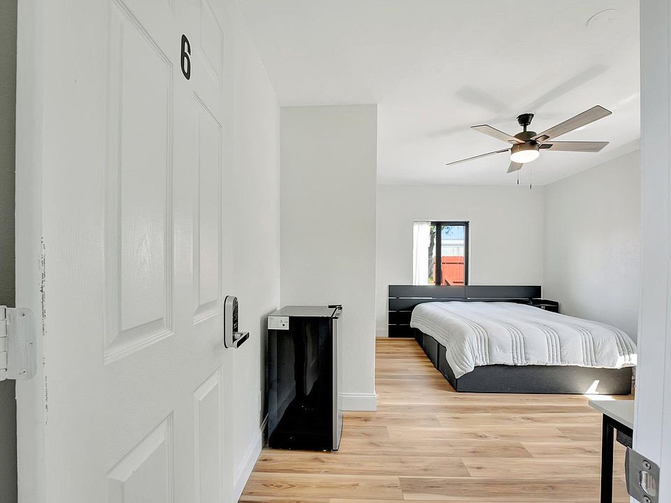 Master bedroom with private bathroom, minifridge, tv and desk.