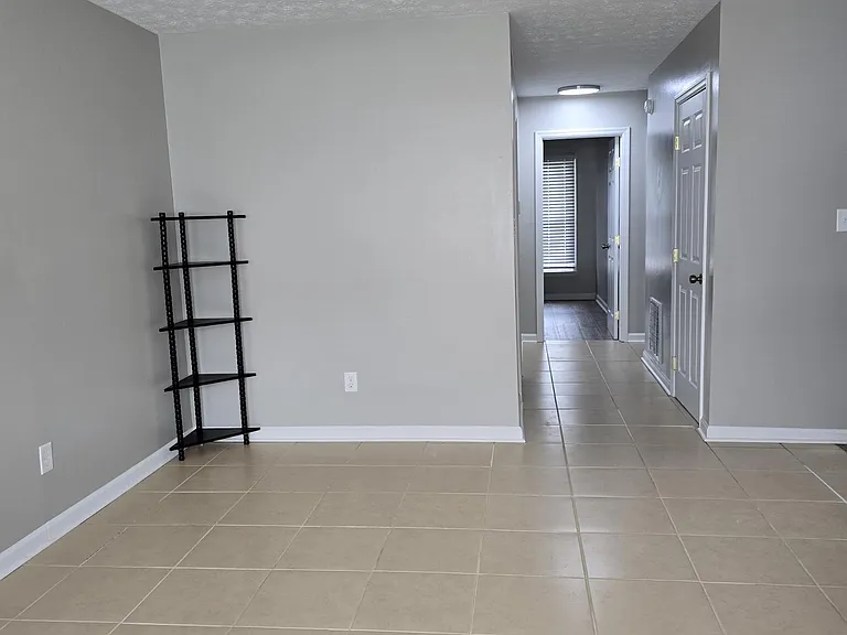 View from front window of living room and hallway to bath and bedrooms.