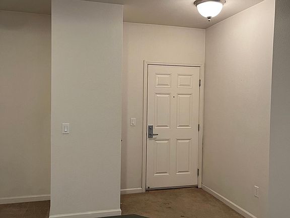 View of front door from kitchen.