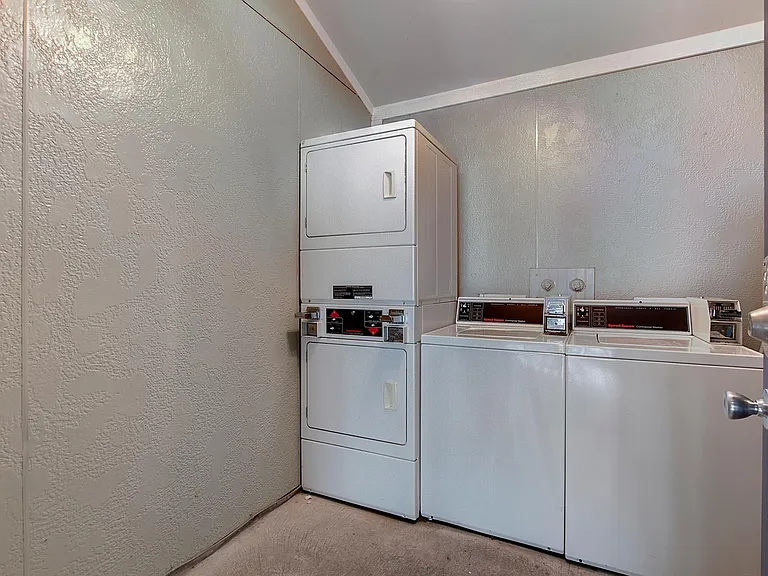 Shared laundry room with ample machines.