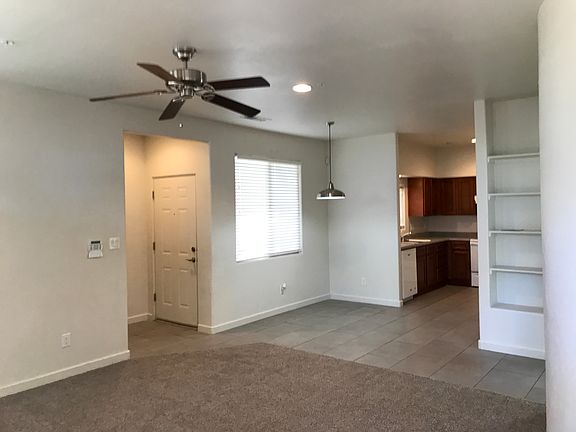 buil-in bookcase in living room with ceiling fan. Breakfast nook eating area
