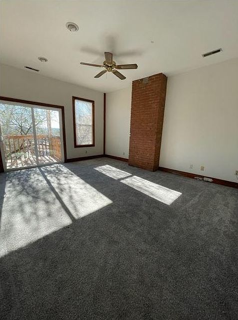Living Room - Natural light and exposed brick. Sliding door to deck.