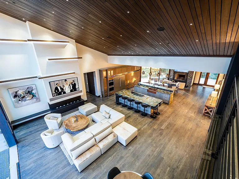 Main level great room, with fireplace, 85" TV, custom lighting, 25' multi slide door that opens to outdoor fire pit