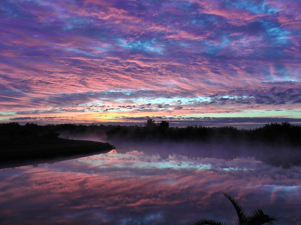 Sunrises, as seen from the waterfront of this home, can provide stunning displays of the interactions of the lake, the sky, and the wilderness of the Boggy Creek Basin.