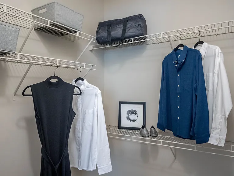 Experience unmatched organization and style in the master bedroom's walk-in closet with staggered shelving.