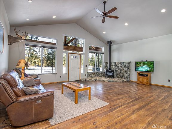 Great room with big windows to let in the natural light. They really showcase the front porch beams.