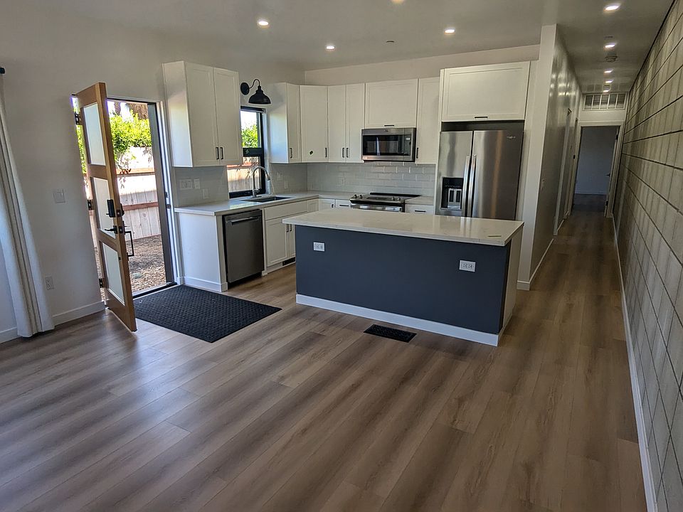 Living Room looking towards Kitchen. Kitchen has a large island to gather around