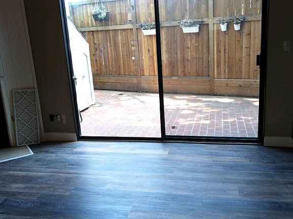 Living room leads to spacious outdoor patio and features brand new luxury vinyl flooring.