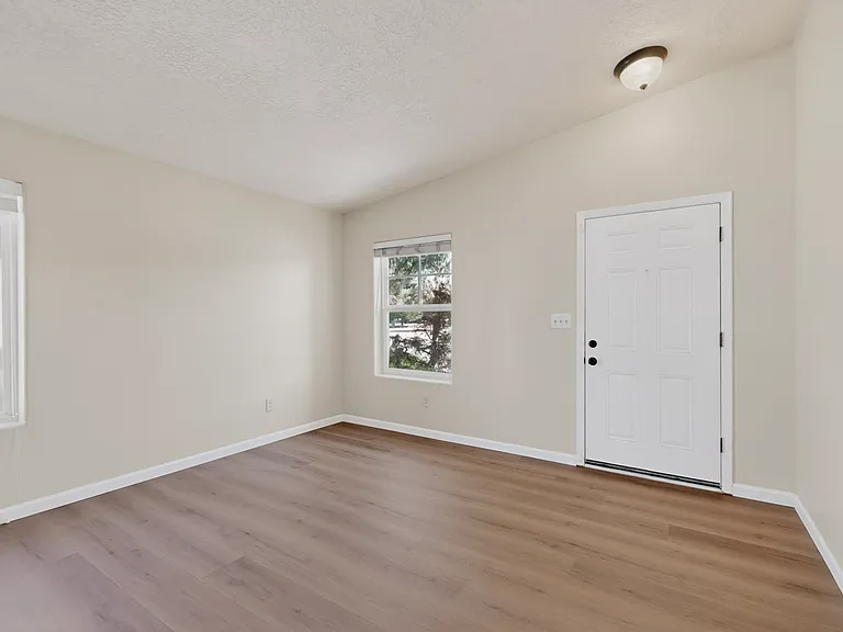 The flexible front entry room could be used as a den or formal dining space. Greet your guests with style!