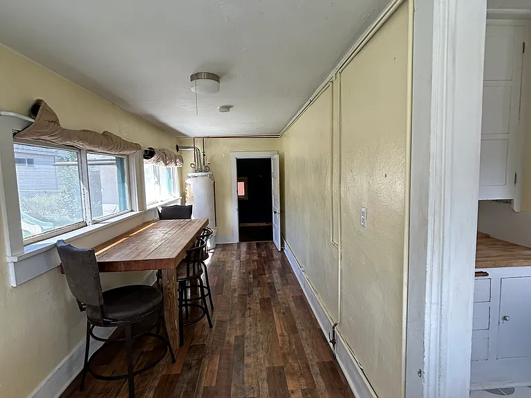 The hallway may be long and quirky, but it's making it work! Set up with a long table for cozy breakfasts and lined with windows. Awkward? Maybe. Functional and full of charm? Definitely.