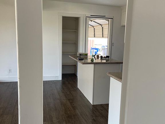 Entry door looking to the right at kitchen with garage access.