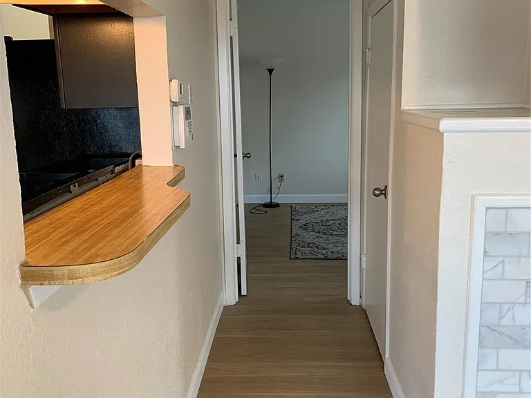 hallway leading to downstairs bedroom