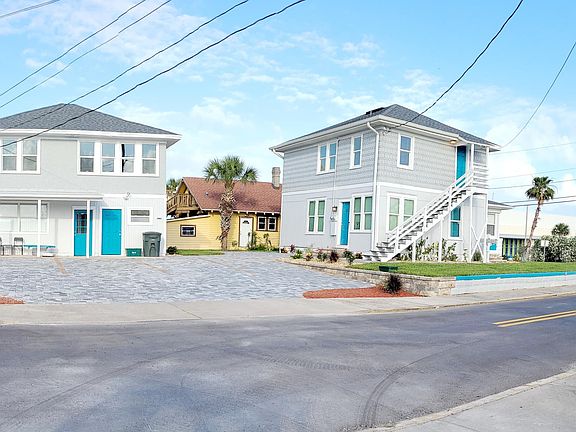 Studio is on the first floor of house on left.