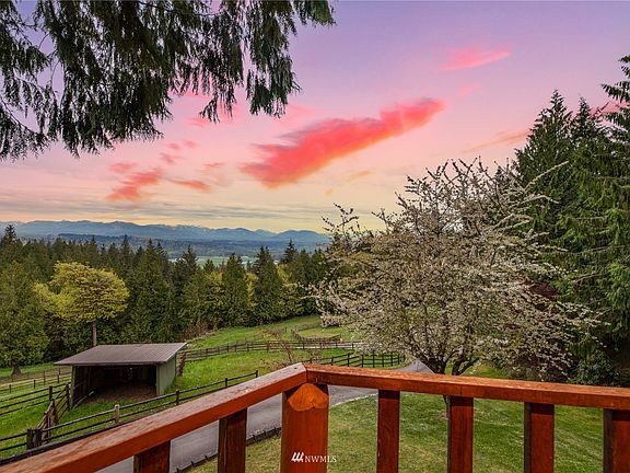 The land gently slopes to the West, providing an unobstructed view of the Olympic mountains in the distance. Notice the fenced and cross-fenced paddocks with small outbuilding which provides shelter for your livestock.