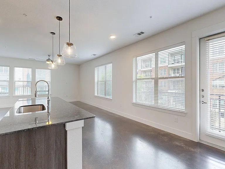 Apartment living room with polished concrete flooring.