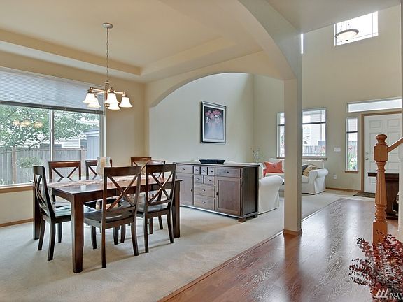 Entry view of the Living room with it's high ceiling and the dining room