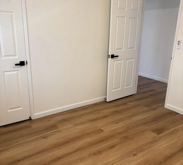Additional view of Bedroom #2, entirely renovated with all new flooring, paint, window covering, doors and light features.