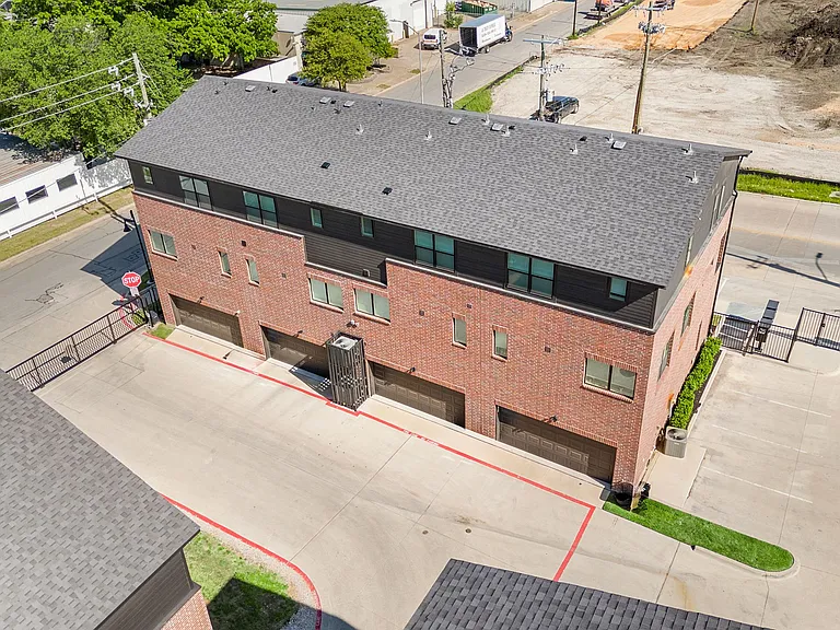 Exterior, aerial view of two-car garage and gated parking lot and street. Additional tenant parking on the right.