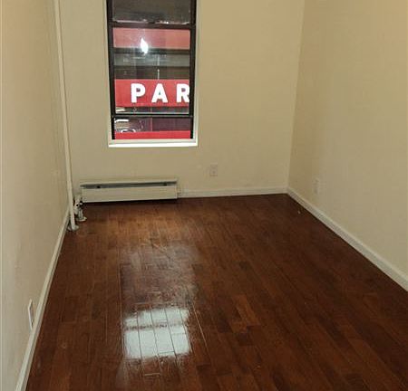 Bedroom 2 with new 3/4" hardwood floors in front of apartmen