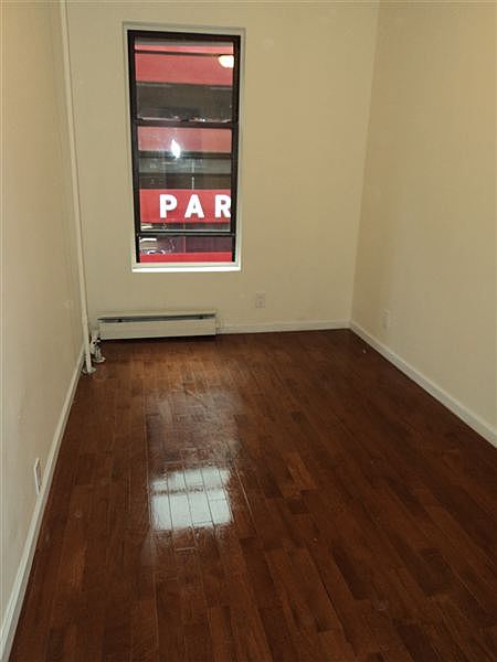 Bedroom 2 with new 3/4" hardwood floors in front of apartmen