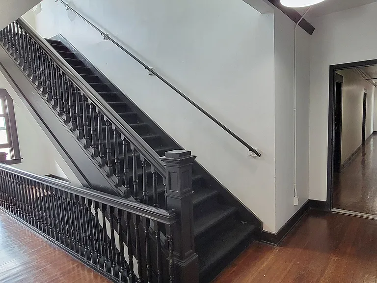 Staircase and wooden floors in the Western at Rosewood apartments in Los Angeles, California.