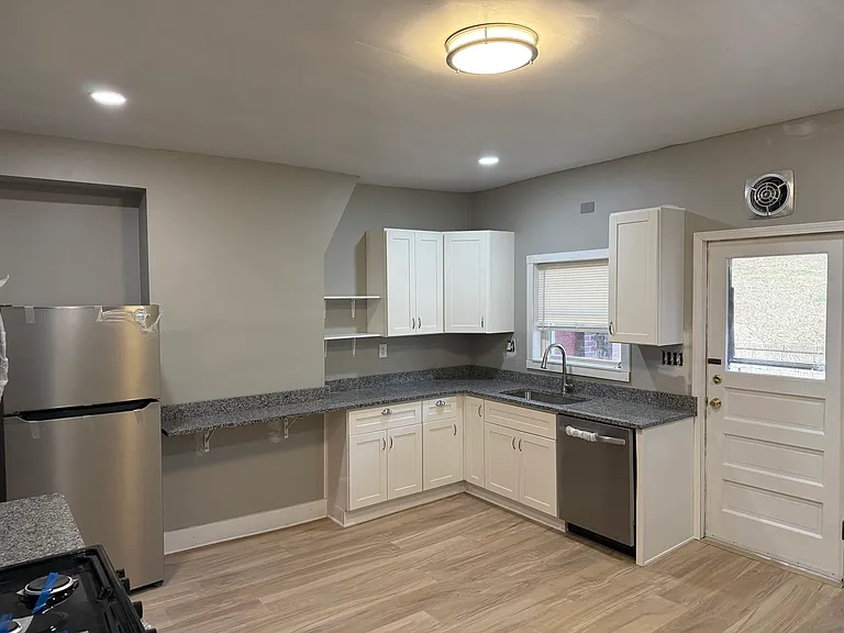 Kitchen with door to rear.