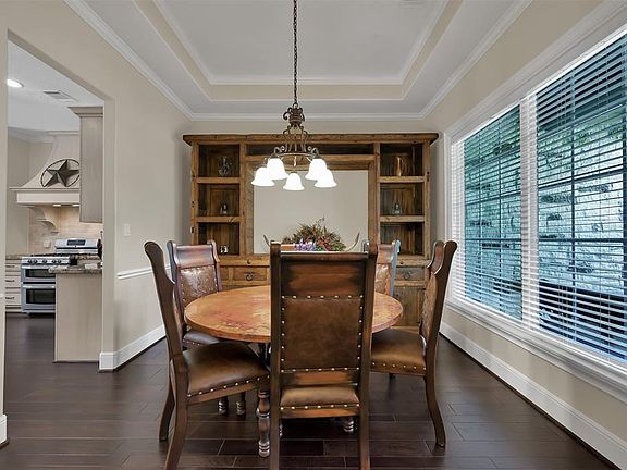 Formal Dining Looking out to your huge front yard. 2"Blinds Through-out.