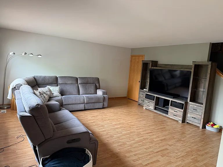 Living room with door to English basement