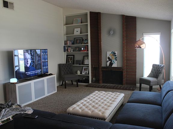 living room with wood burning/ gas fireplace