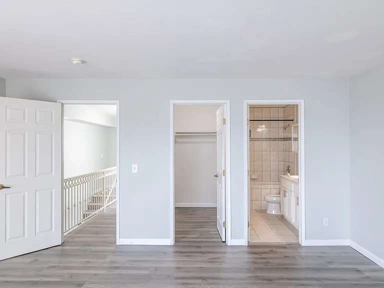 Primary bedroom - entrances to ensuite bathroom & closet