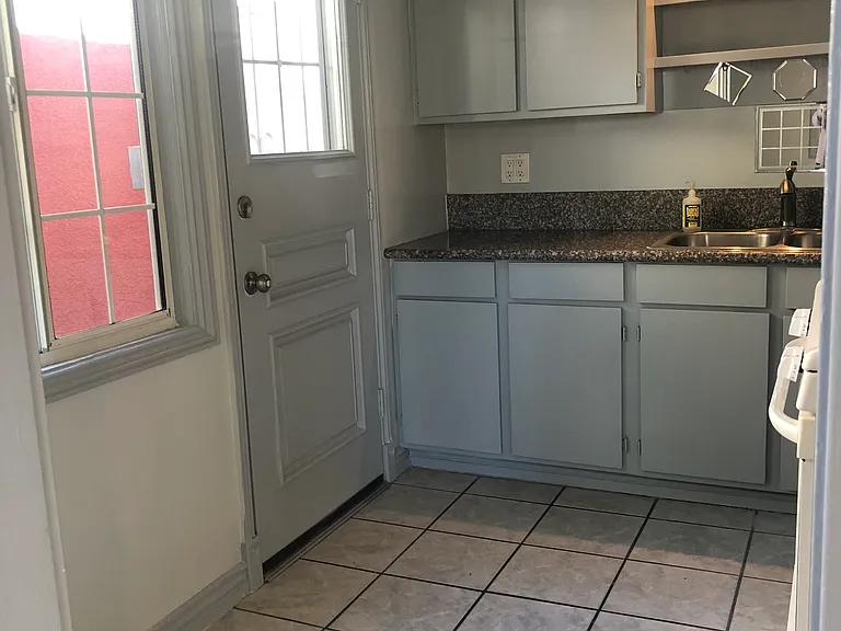 Kitchen and side door to side patio and laundry room
