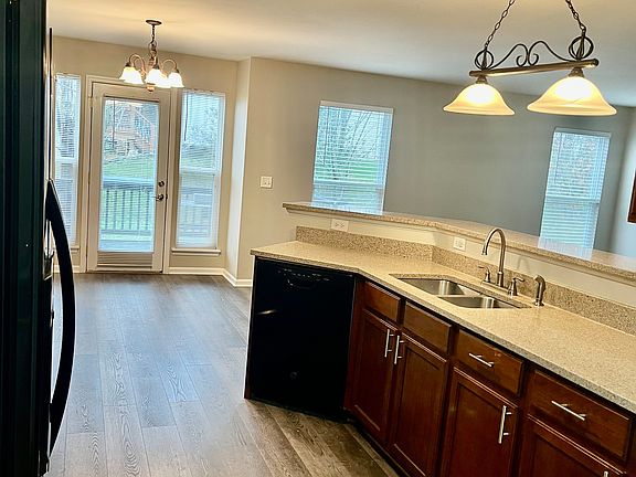 Kitchen includes a pantry and all appliances: side-by-side refrigerator, range, microwave, and dishwasher