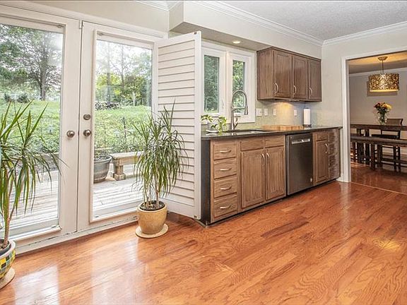 Updated kitchen overlooking backyard oasis.
