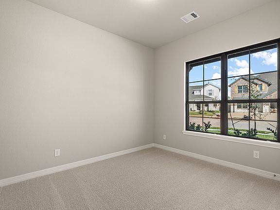 Your secondary bedroom features plush carpet, fresh paint, closet, and a large window that lets in p