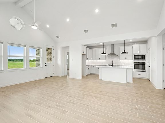 Soaring vaulted ceiling unites main living areas