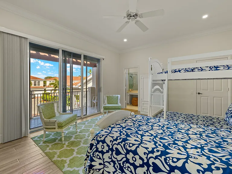 2nd bedroom with view out to balcony