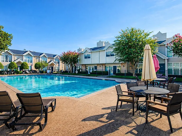 Beautifully maintained pool area with outdoor seating and landscaped surroundings.