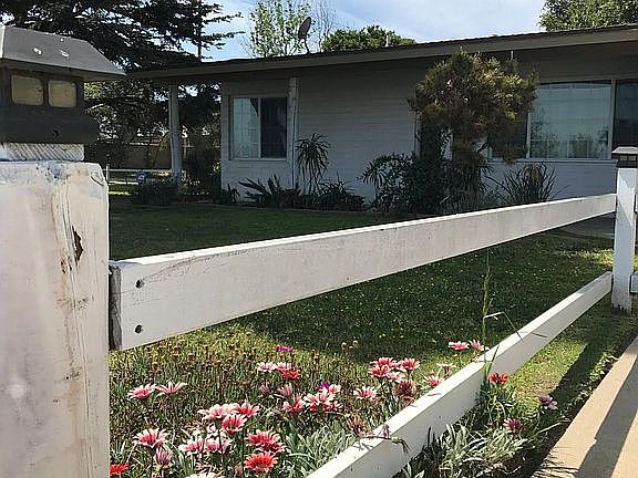Large fenced in yard in ranch style.