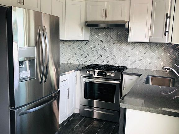 New kitchen cabinet, quartz countertop, full kitchen backsplash, ice maker refrigerator, stove, dishwasher, garbage disposal.