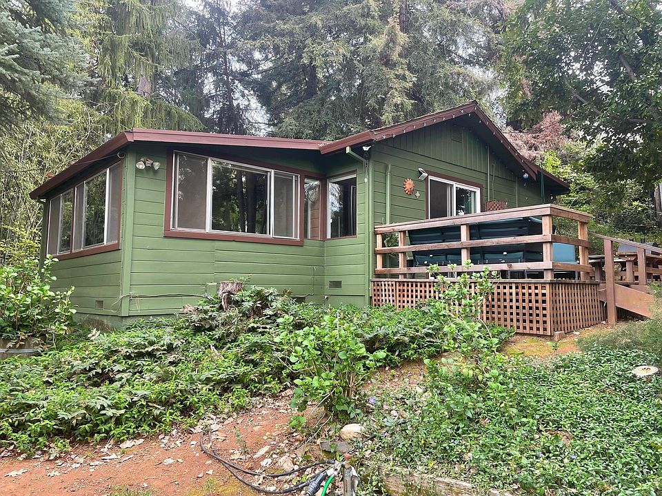 Front of Cottage as seen from the driveway. Entrance is via the stairs and deck to the right.