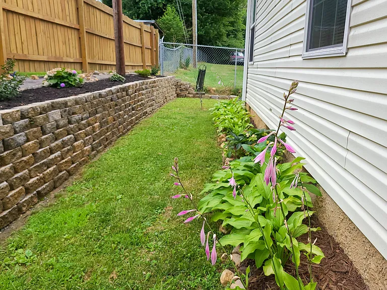 Flowers and room to play! Please note: the back retaining wall is under construction due to the national shortage of construction materials. The backyard is a great play place, otherwise!