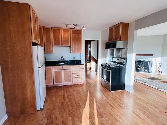 Dining room and kitchen from back windows. New appliances, renovated cabinets, new hardwood floors throughout apartment.