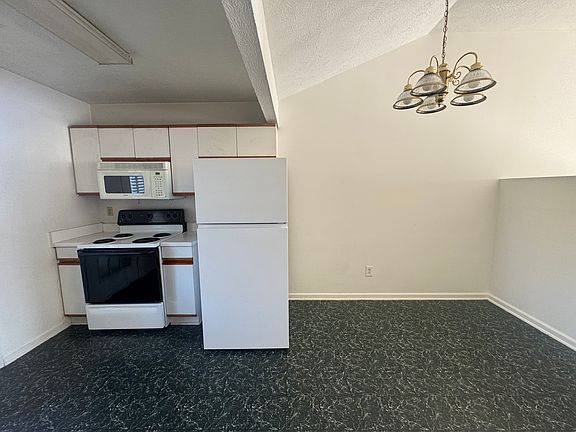The kitchen is both practical and cozy, featuring a dishwasher, stove, and Nook for a table.