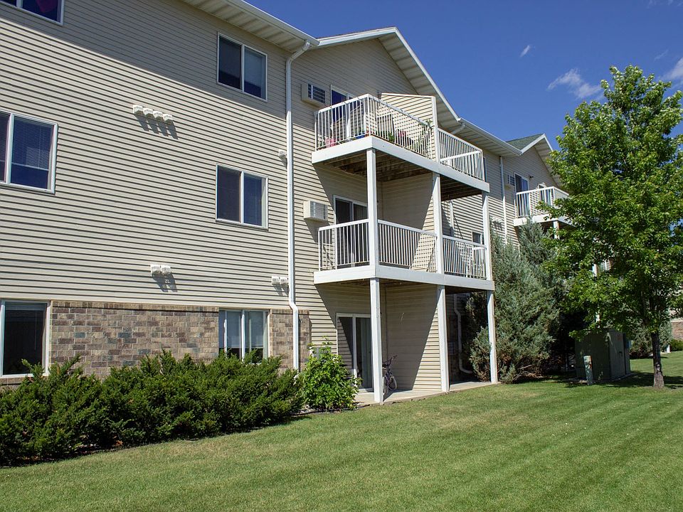 The exterior of Amber Fields, showcasing the green lawn and views of the balconies and patios