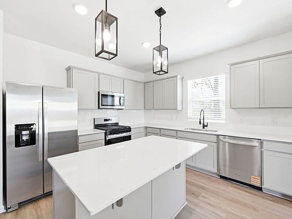 Kitchen with Designer Inspired Pendants over Center Island