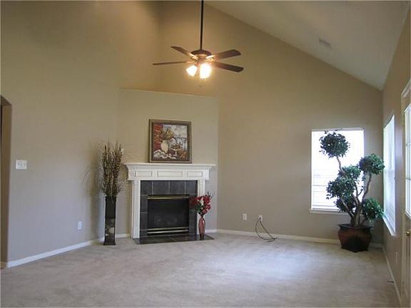   High ceiling family room with fireplace.