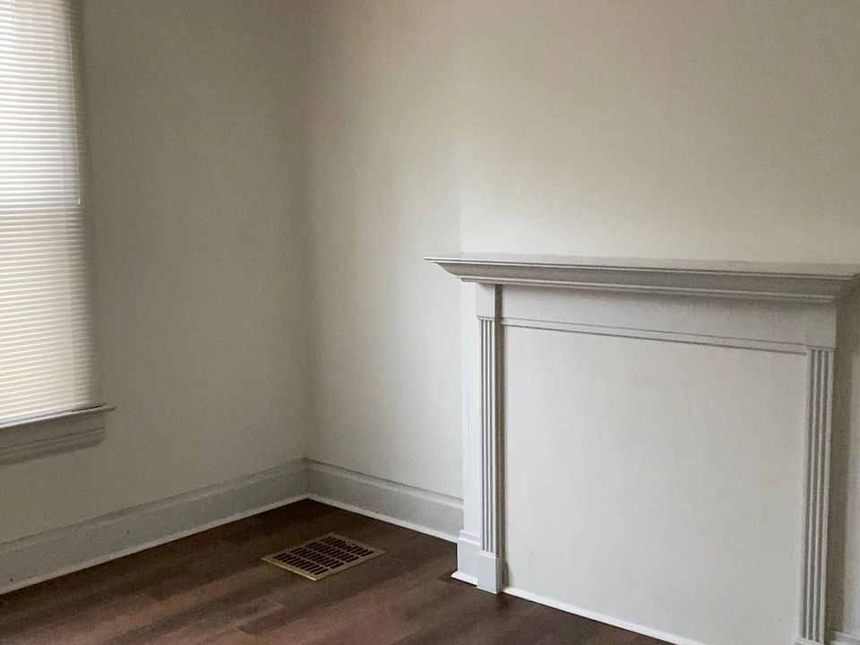 Living room with decorative fireplace and new flooring